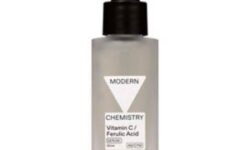 A short rectangular clear frosted glass bottle with a black rubber pipette lid and a white label that has Boots Modern Chemistry Glow 10% Vitamin C Serum with Ferulic Acid written in bold black writing on it, on a white background.